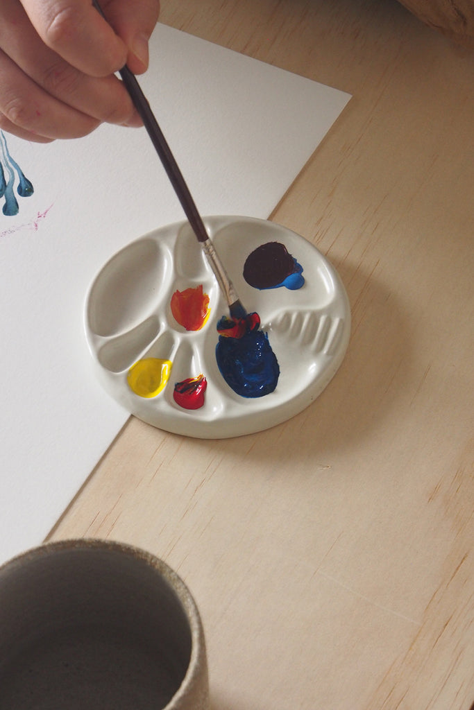 palette in use, with paint and a paint brush